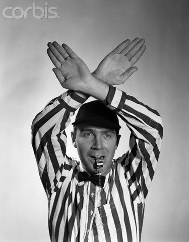 1950s Football Referee Making Hand Signal Time Out Blowing Whistle